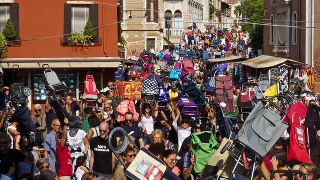 Hundreds of angry Venetians have protested tourism in their city, brandishing shopping carts and prams.